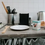 Cluttered kitchen counter with too many utensils showing tool buying mistakes