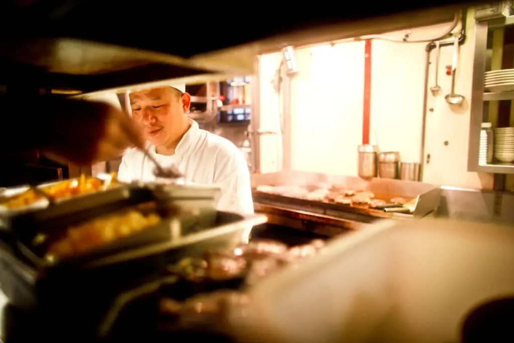 Chef working at an organized kitchen station with tools supporting efficient workflow