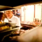 Chef working at an organized kitchen station with tools supporting efficient workflow