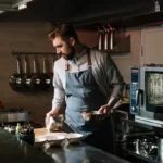 Professional chef inspecting kitchen tools for quality and reliability